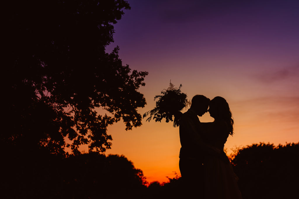 Silhouette of Husband and Wife Genevieve & John Kissing at Sunset at Ivy House Country Hotel