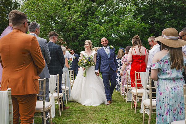 couple walking down aisle